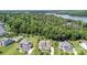 Backyard featuring a pool, trampoline, and manicured lawn, surrounded by mature trees at 112 S Shore Dr, Belmont, NC 28012