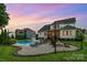 Backyard oasis featuring a pool, hot tub, and fire pit for ultimate outdoor enjoyment at 112 S Shore Dr, Belmont, NC 28012