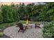 Outdoor fire pit area with Adirondack chairs and string lights for relaxing evenings at 112 S Shore Dr, Belmont, NC 28012