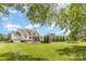Expansive backyard with a pool, lush lawn, mature trees, and a white two-story house at 112 S Shore Dr, Belmont, NC 28012