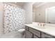 Neutral bathroom with gray vanity, decorative shower curtain, and modern fixtures at 112 S Shore Dr, Belmont, NC 28012