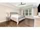 This bedroom features hardwood floors, a ceiling fan, and a large window for natural light at 112 S Shore Dr, Belmont, NC 28012