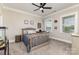 This carpeted bedroom features natural light, ceiling fan, and neutral decor at 112 S Shore Dr, Belmont, NC 28012