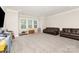Spacious bonus room with new carpet, large windows, and room for furniture at 112 S Shore Dr, Belmont, NC 28012