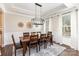 Formal dining room with a modern chandelier, decorative wall art, and hardwood floors at 112 S Shore Dr, Belmont, NC 28012