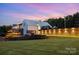 Stunning modern building with brick accents, expansive glass, beautiful lighting, and lush green lawn at 112 S Shore Dr, Belmont, NC 28012