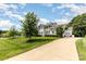 Charming two-story home with a double porch, black shutters, attached garage and long driveway at 112 S Shore Dr, Belmont, NC 28012