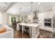 Open-concept kitchen with a large island, stainless steel appliances, and hardwood floors at 112 S Shore Dr, Belmont, NC 28012