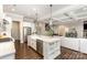 Bright kitchen featuring a large island with seating, stainless appliances, and hardwood floors at 112 S Shore Dr, Belmont, NC 28012