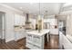 Modern kitchen with stainless steel appliances, a large island, and hardwood floors at 112 S Shore Dr, Belmont, NC 28012
