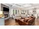 Bright open-concept living room features a coffered ceiling, fireplace and hardwood floors at 112 S Shore Dr, Belmont, NC 28012