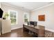 Well-lit home office with hardwood floors, large windows and a spacious desk at 112 S Shore Dr, Belmont, NC 28012