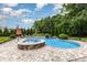 Backyard showcasing a pool, hot tub and lounge chairs under a bright blue sky at 112 S Shore Dr, Belmont, NC 28012