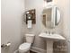 Stylish powder room featuring a pedestal sink, decorative mirror, and modern fixtures at 112 S Shore Dr, Belmont, NC 28012