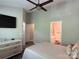 Comfortable bedroom with modern furnishings, including a TV, dresser, and an attached bathroom at 1139 Drummond Ln, Matthews, NC 28104