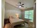 Cozy bedroom featuring a ceiling fan, a plush bed, and a window offering natural light at 1139 Drummond Ln, Matthews, NC 28104