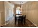 Elegant dining area featuring stylish lighting, wood floors, and seamless connection to other living spaces at 1139 Drummond Ln, Matthews, NC 28104