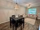 Cozy dining area with a modern chandelier, wood flooring, and comfortable seating for stylish entertaining at 1139 Drummond Ln, Matthews, NC 28104
