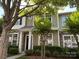 Charming two-story townhome showcasing stone and siding accents, complemented by lush greenery and a welcoming entryway at 1139 Drummond Ln, Matthews, NC 28104