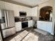 Well-lit kitchen with stainless steel appliances, granite countertops, and white cabinetry, exuding a modern and clean aesthetic at 1139 Drummond Ln, Matthews, NC 28104