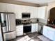 Well-equipped kitchen with stainless steel appliances, ample counter space, and white cabinetry at 1139 Drummond Ln, Matthews, NC 28104