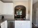 Bright kitchen with stainless steel dishwasher, and a view into the adjacent living room at 1139 Drummond Ln, Matthews, NC 28104
