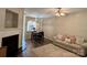 Warm living room showcasing a fireplace, comfortable seating, stylish lighting, and seamless access to the dining area at 1139 Drummond Ln, Matthews, NC 28104