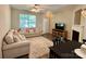 Cozy living room with plush seating, a fireplace, a ceiling fan, and a neutral color palette at 1139 Drummond Ln, Matthews, NC 28104