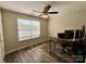 Well-lit office space with hardwood floors, a ceiling fan, and a large window at 1139 Drummond Ln, Matthews, NC 28104