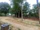 A grassy backyard features mature trees at 117 Marakery Rd # B, Mooresville, NC 28115