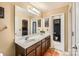Bright bathroom featuring a double sink vanity with dark wood cabinets and a large mirror at 117 Marakery Rd # B, Mooresville, NC 28115