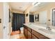 A bright bathroom features double sinks, a large mirror, and a shower with a dark curtain at 117 Marakery Rd # B, Mooresville, NC 28115