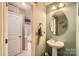 A traditional half bathroom features a pedestal sink and neutral color scheme at 117 Marakery Rd # B, Mooresville, NC 28115