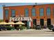The A Lino Pizzeria building has a brick facade, tall windows, and umbrellas over the outdoor seating area at 117 Marakery Rd # B, Mooresville, NC 28115