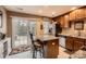 A well-lit kitchen features wooden cabinets, granite counters, stainless appliances, and access to an outdoor patio at 117 Marakery Rd # B, Mooresville, NC 28115