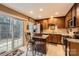 A bright kitchen with wooden cabinets, granite countertops, stainless appliances, and access to the outdoors at 117 Marakery Rd # B, Mooresville, NC 28115