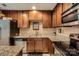 Modern kitchen featuring granite countertops, stainless steel appliances, and warm wood cabinets at 117 Marakery Rd # B, Mooresville, NC 28115