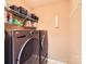 Modern laundry room with front-loading washer and dryer, and overhead shelving for storage at 117 Marakery Rd # B, Mooresville, NC 28115