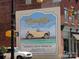 Historic Franklin Automobile Company advertisement painted on a brick building with a yellow antique car at 117 Marakery Rd # B, Mooresville, NC 28115