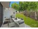 A backyard patio features an outdoor dining area with seating for six and views of the yard at 117 Marakery Rd # B, Mooresville, NC 28115