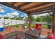 Inviting covered patio featuring an outdoor seating area, string lights, and backyard views at 1177 Bannockburn Ave, Rock Hill, SC 29732