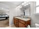 Bathroom featuring a dual sink vanity with granite countertops, wood cabinetry, and neutral walls at 1177 Bannockburn Ave, Rock Hill, SC 29732