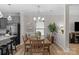 Well lit dining room with a kitchen in the background, perfect for Gathering meals and entertaining at 1177 Bannockburn Ave, Rock Hill, SC 29732