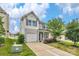 Two-story home featuring a one-car garage, a well-maintained lawn, and a charming front porch at 1177 Bannockburn Ave, Rock Hill, SC 29732