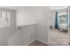 Hallway leading to bedroom with chair and window and stairs on left at 1177 Bannockburn Ave, Rock Hill, SC 29732
