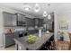 Close-up of kitchen island featuring granite countertop, modern faucet and sink, with stainless steel appliances at 1177 Bannockburn Ave, Rock Hill, SC 29732