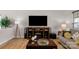 Bright living room featuring hardwood floors, a large entertainment center, and comfortable seating area at 1177 Bannockburn Ave, Rock Hill, SC 29732
