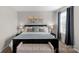 Comfortable bedroom featuring a bench, large bed, and lamps and a bright window at 1177 Bannockburn Ave, Rock Hill, SC 29732