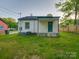 Backyard of home with a small porch and a partial view of the yard at 123 Oak St, Chester, SC 29706