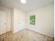 Fresh bedroom showcasing stylish flooring, a large window, and two entry doors at 123 Oak St, Chester, SC 29706